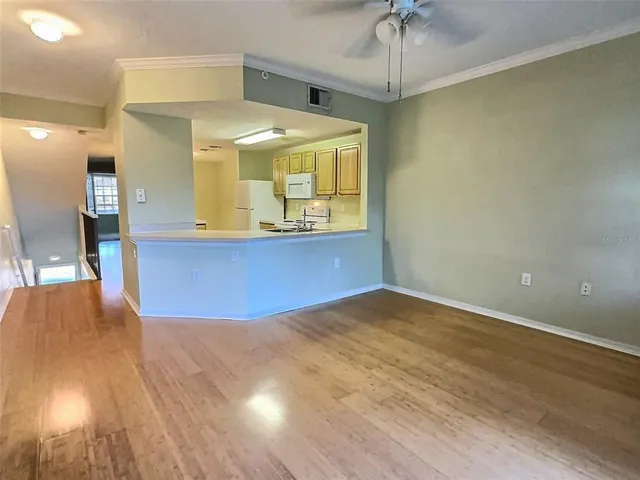 a view of a room with a window and wooden floor