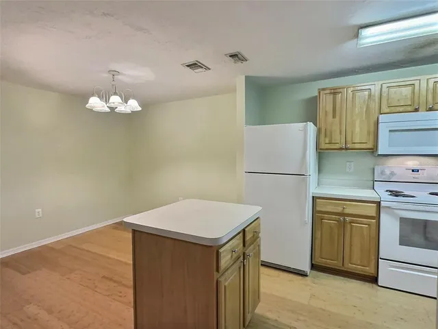 a kitchen with stainless steel appliances a refrigerator sink and stove