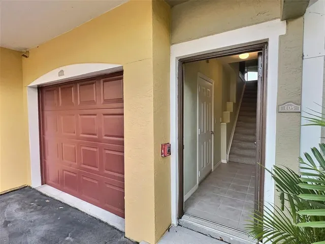 a view of a hallway with wooden door