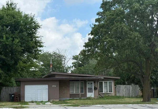 a house that has tree in front of it