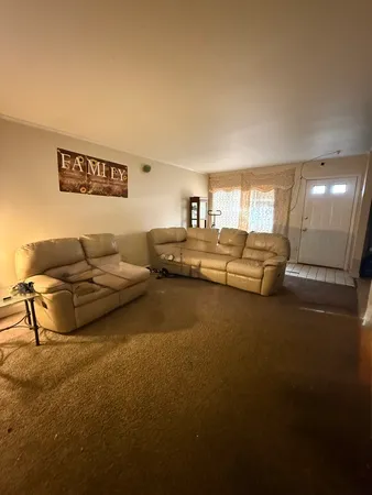 a living room with furniture and a pool table