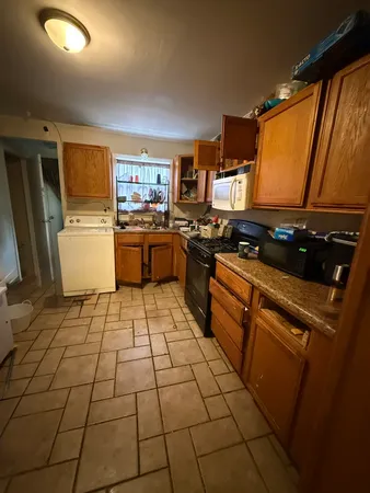 a kitchen with a sink a stove cabinets and counter space