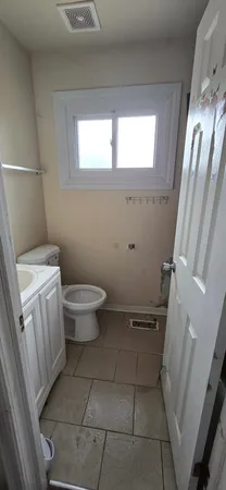 a bathroom with a toilet and a sink