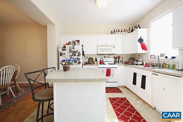 a kitchen with stainless steel appliances granite countertop a sink and a stove