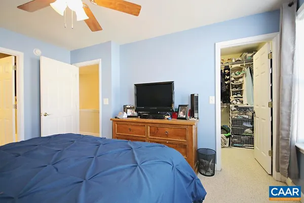 a bedroom with furniture and a flat screen tv