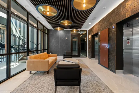 a lobby with furniture and window