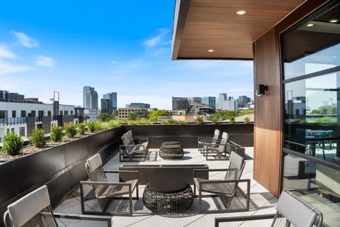 a view of a chairs and table in a balcony