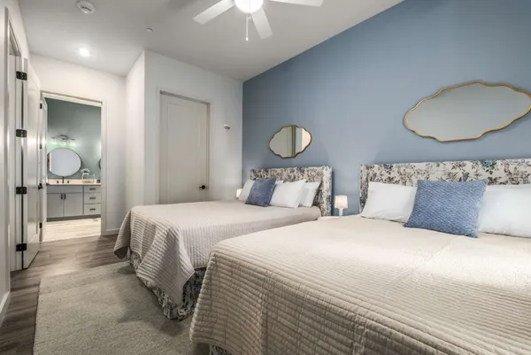 a bedroom with bed and a chandelier