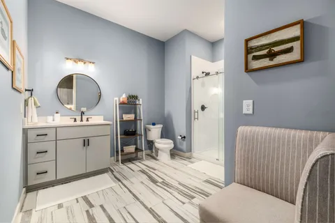 a spacious bathroom with a double vanity sink and a mirror