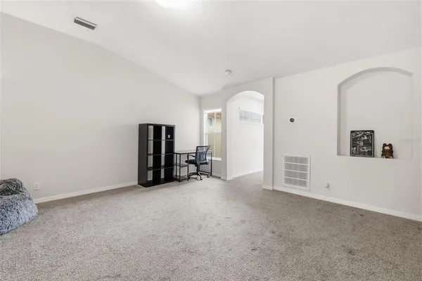 an empty room with closet and mirror
