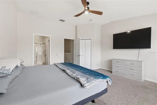 a bedroom with a bed and a flat screen tv