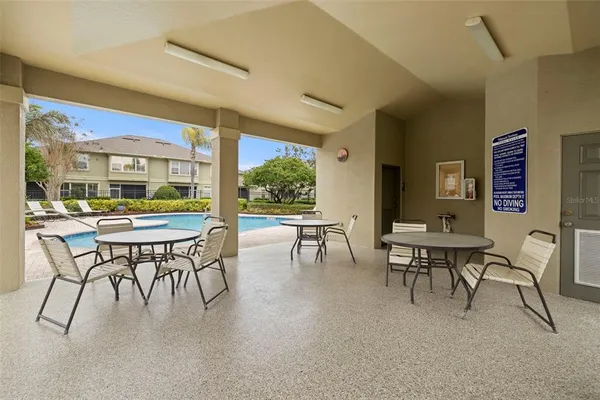 a view of a dining room with furniture and a large window