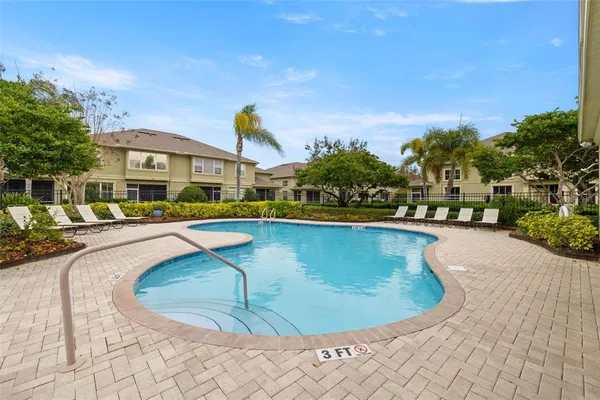 a view of a swimming pool with outdoor seating