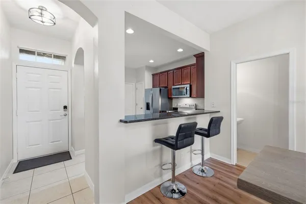 a kitchen with stainless steel appliances granite countertop a refrigerator and a stove top oven