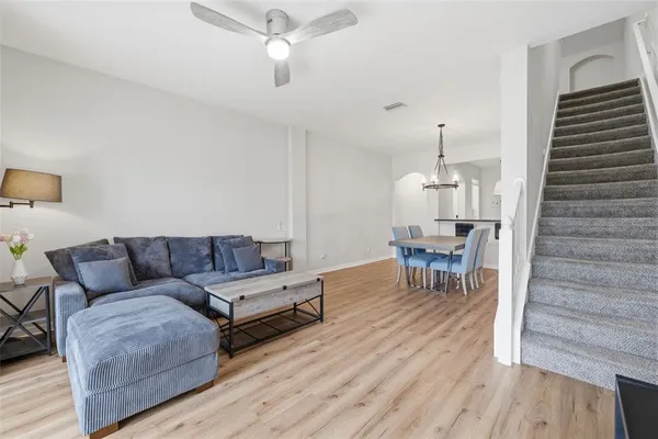 a living room with furniture and a wooden floor