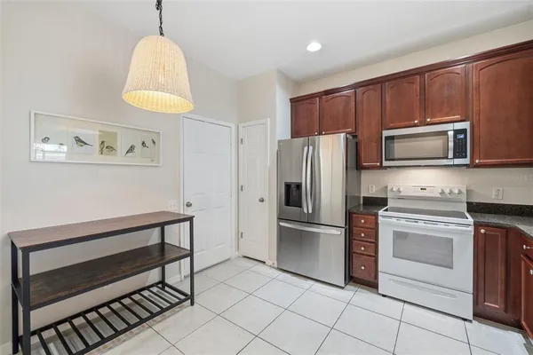 a kitchen with stainless steel appliances a stove a refrigerator and a microwave