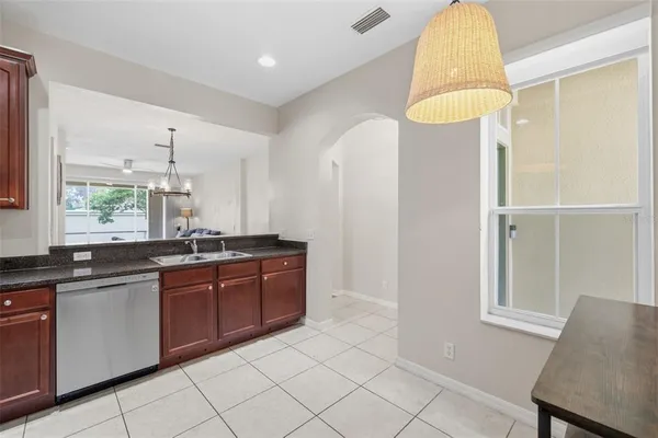 a large bathroom with a granite countertop sink a mirror and a bathtub