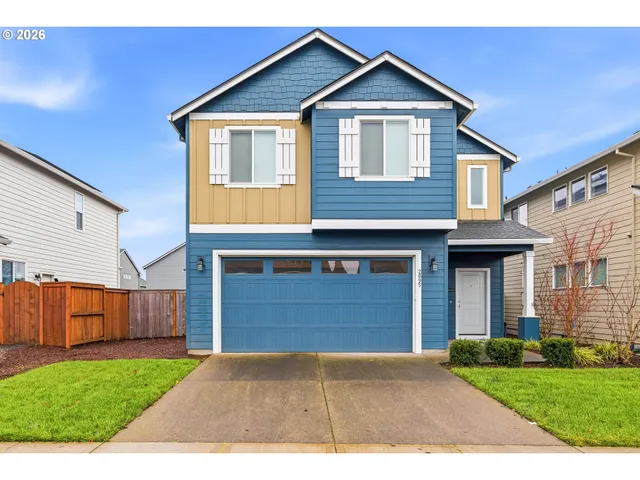 a front view of a house with a yard and garage