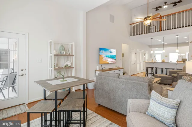a bedroom with a bed a chandelier and dresser