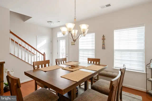 a view of a dining room with furniture and a large window