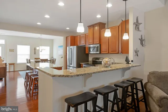 a kitchen with center island table and chairs in it