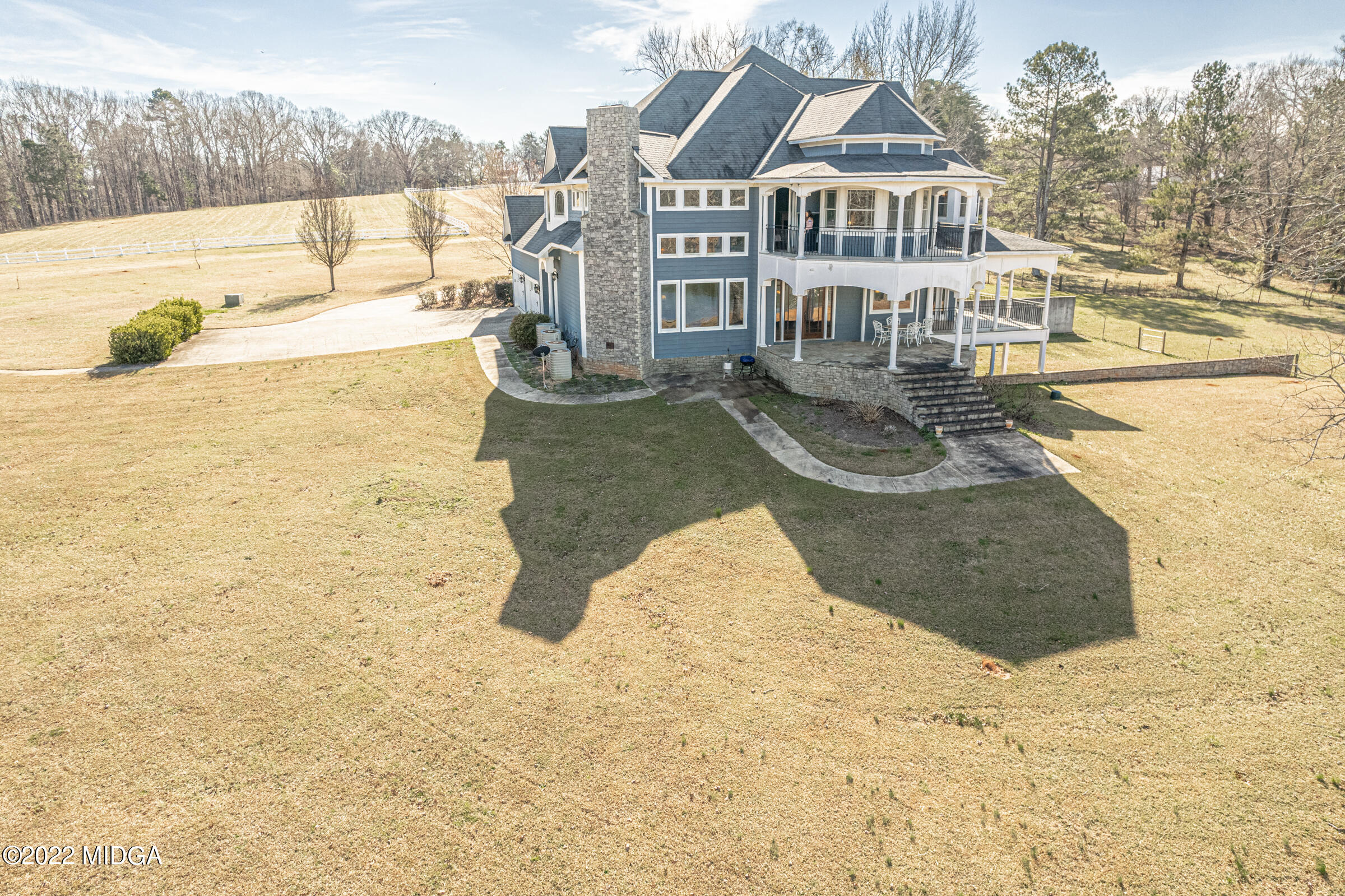643 Bowen Hill Road Gray, GA 31032 - Photo 54 of 64 a view of a white house with a swimming pool and sitting area