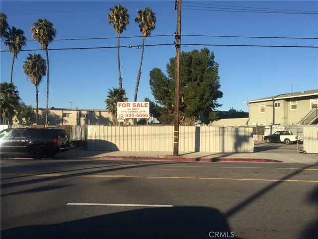 a view of a city street with a car parked on the road