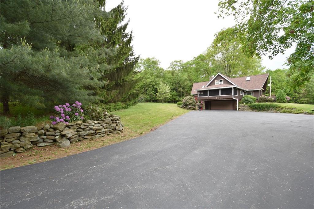 533 Miller Road Franklin, PA 16323 - Photo 22 of 25 Driveway view shows two car garage and screened porch.