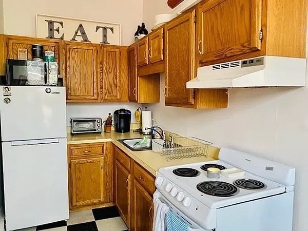 18 Cedar Street, Unit 3 Boston, MA 02129 - Photo 4 of 10 a kitchen with a sink a stove and a refrigerator