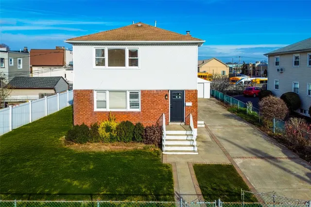 a view of a house with a backyard and a patio