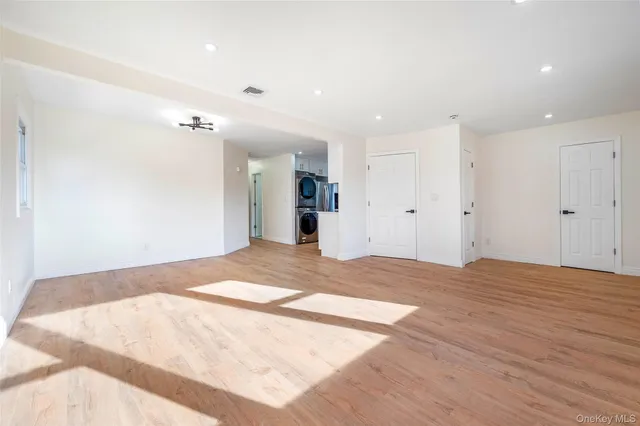 a view of a kitchen with a sink and a refrigerator