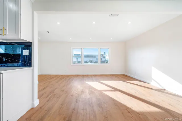 a open kitchen with stainless steel appliances granite countertop a stove a sink and a microwave