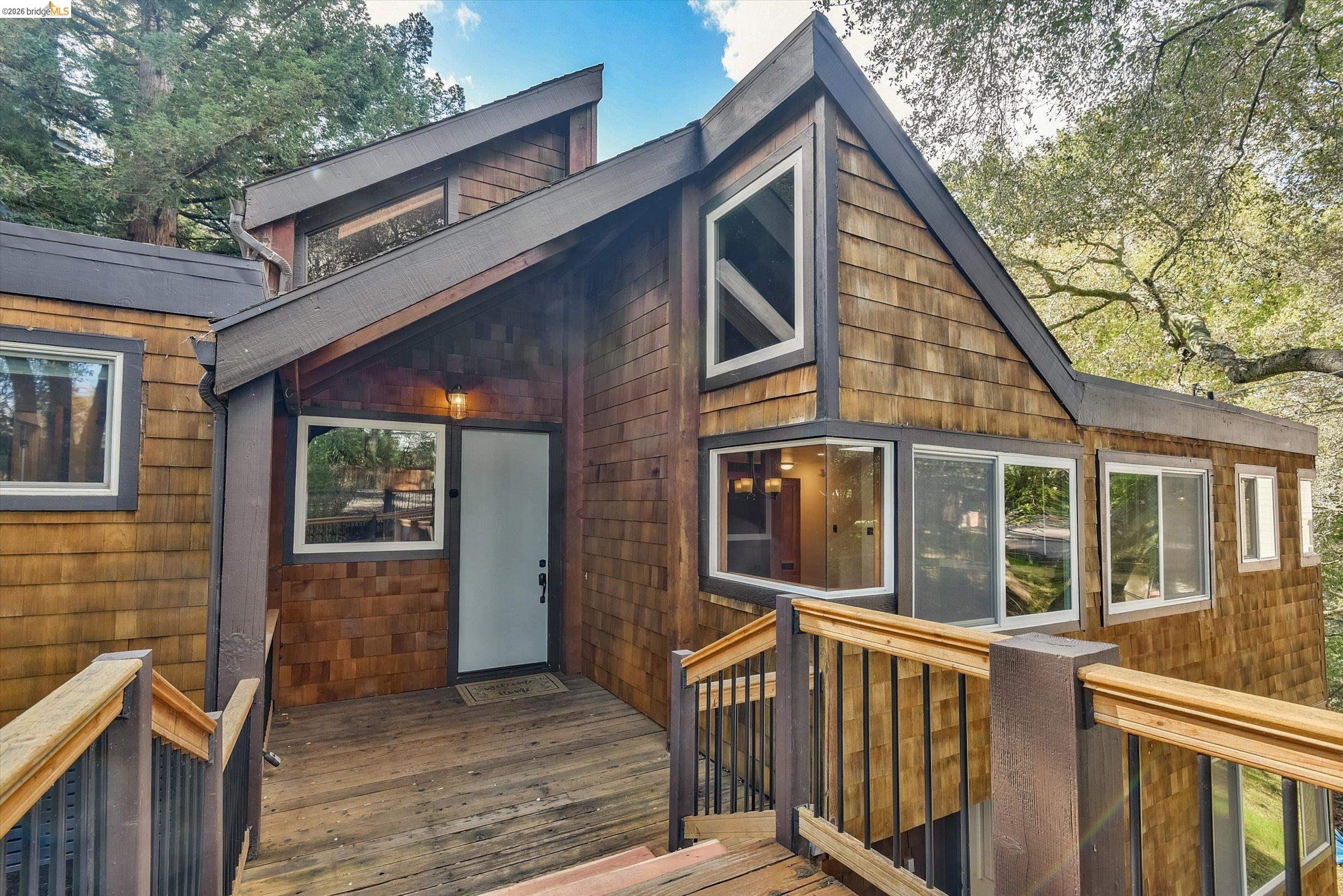 9 Wildwood Road Orinda, CA 94563 - Photo 2 of 34 a front view of a house with large windows