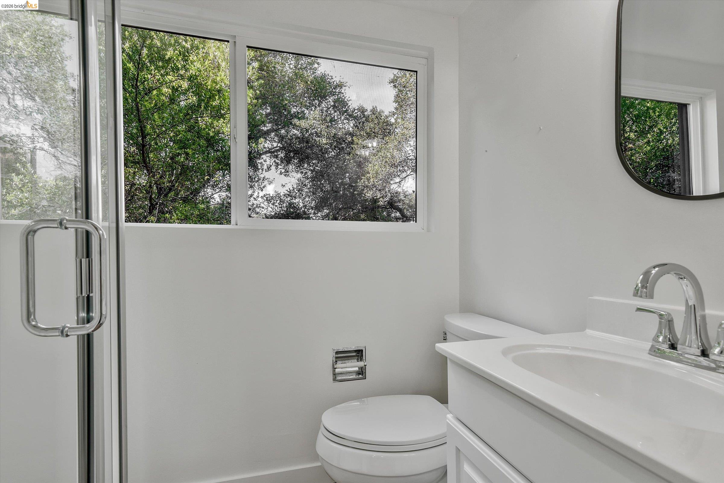 9 Wildwood Road Orinda, CA 94563 - Photo 25 of 34 a bathroom with a toilet a sink and a mirror