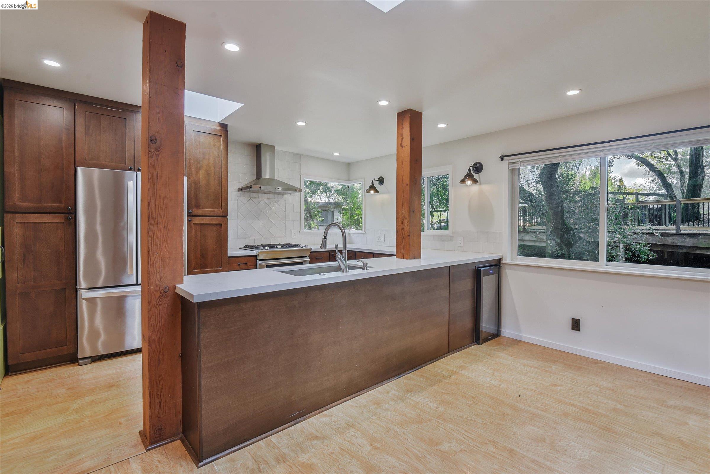 9 Wildwood Road Orinda, CA 94563 - Photo 5 of 34 a large kitchen with stainless steel appliances a large counter top a refrigerator and a sink