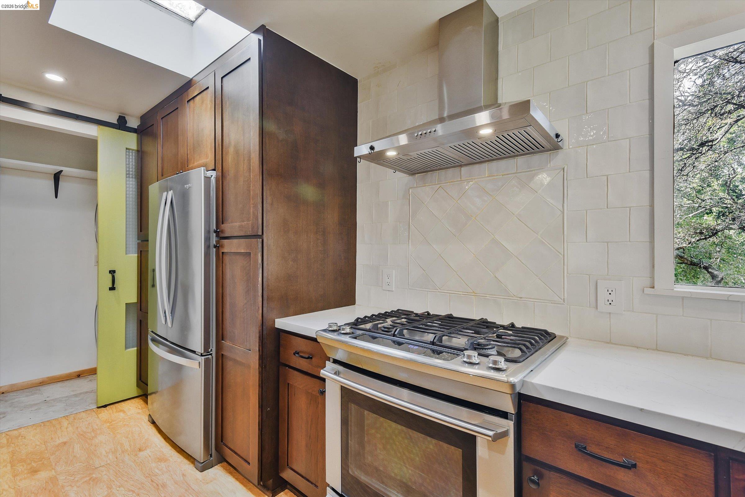 9 Wildwood Road Orinda, CA 94563 - Photo 10 of 34 a kitchen with stainless steel appliances granite countertop a refrigerator and a stove