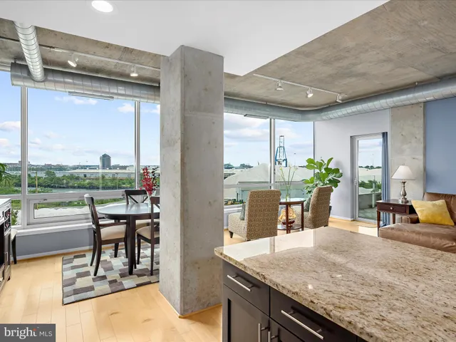 a dining room with furniture and a floor to ceiling window