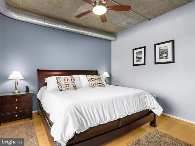 a bedroom with a bed and a large window