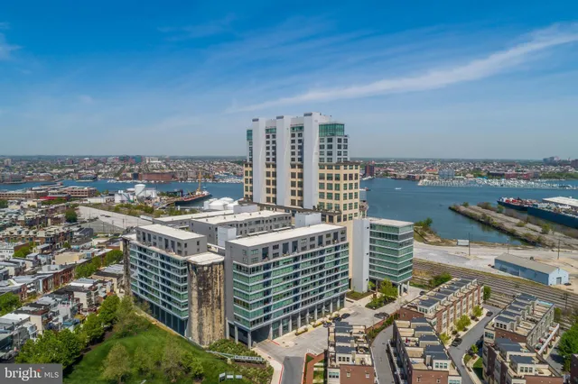 a living room with furniture and floor to ceiling windows
