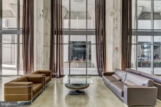 a view of a balcony with chairs and a floor to ceiling window