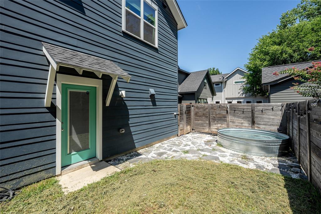 2821 Castro Street, Unit 1 Austin, TX 78702 - Photo 21 of 21 Private courtyard area featuring a stock tank, flagstone patio, and wood privacy fencing