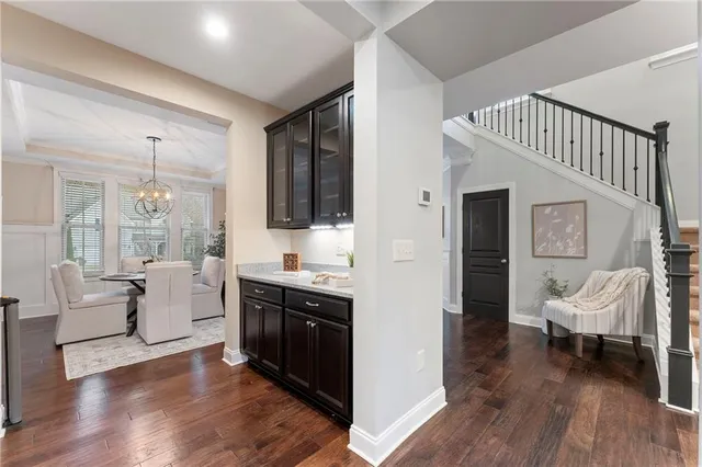 a living room with furniture a fireplace and a chandelier