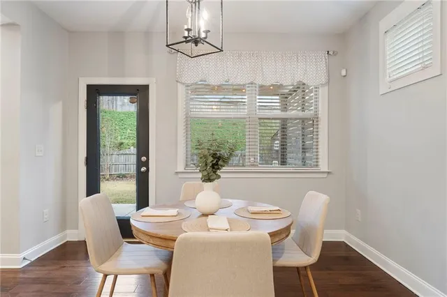 a bedroom with a bed chandelier and a window