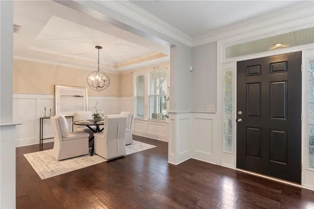 a dining room with furniture a rug and wooden floor