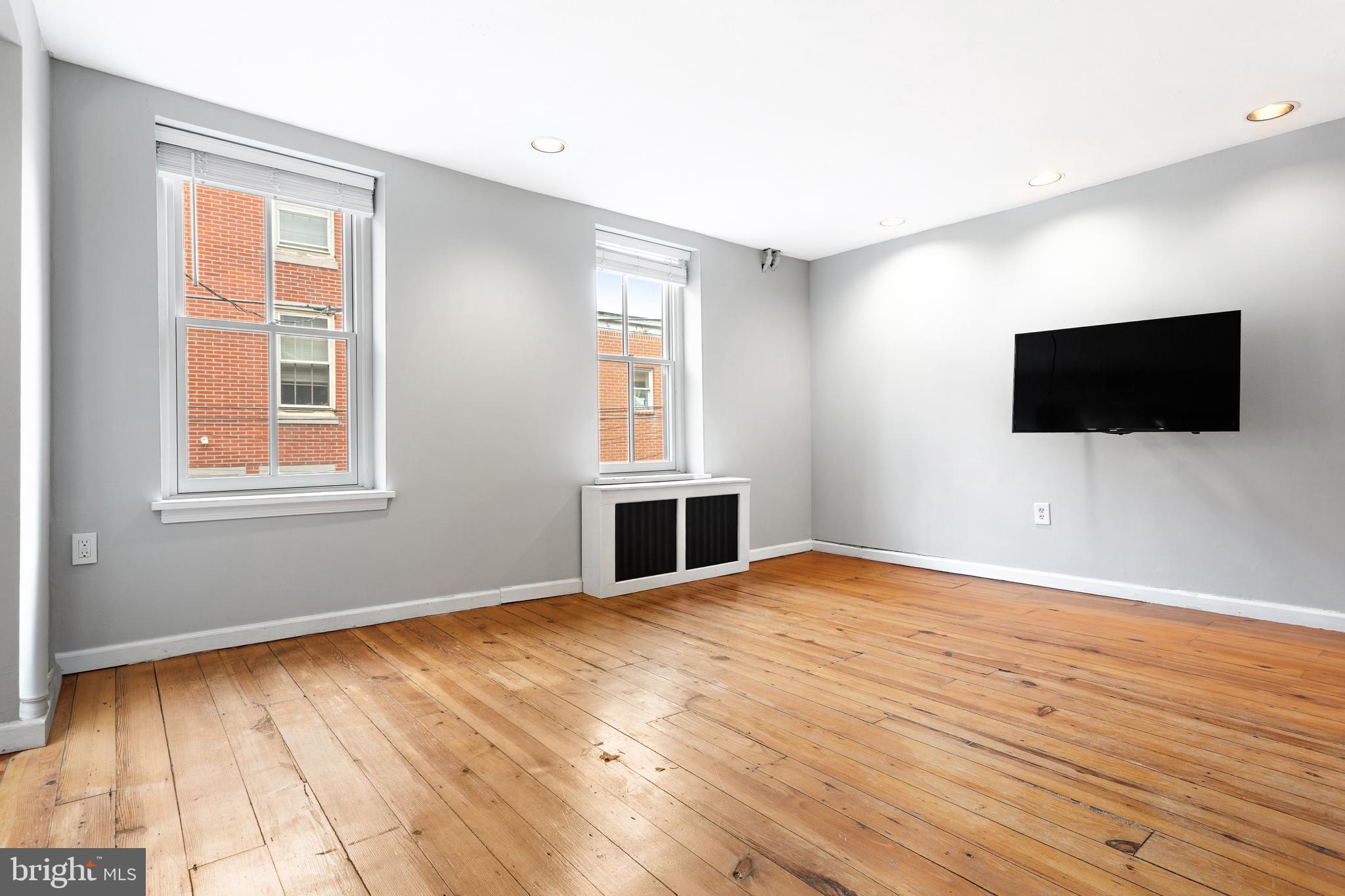 504 Kauffman Street Philadelphia, PA 19147 - Photo 23 of 34 a view of empty room with wooden floor and windows