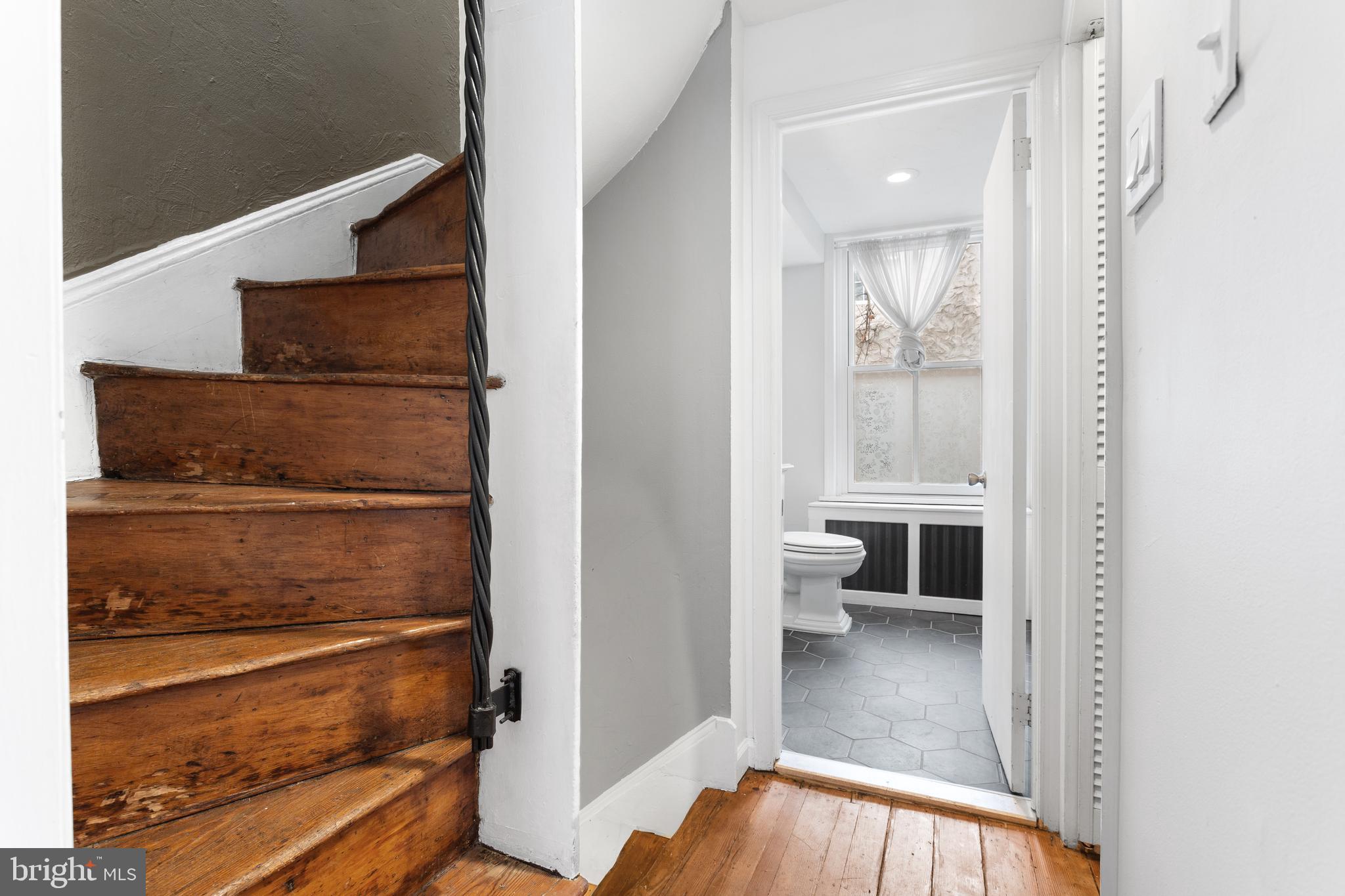504 Kauffman Street Philadelphia, PA 19147 - Photo 26 of 34 a view of a hallway with wooden floor and a bathroom