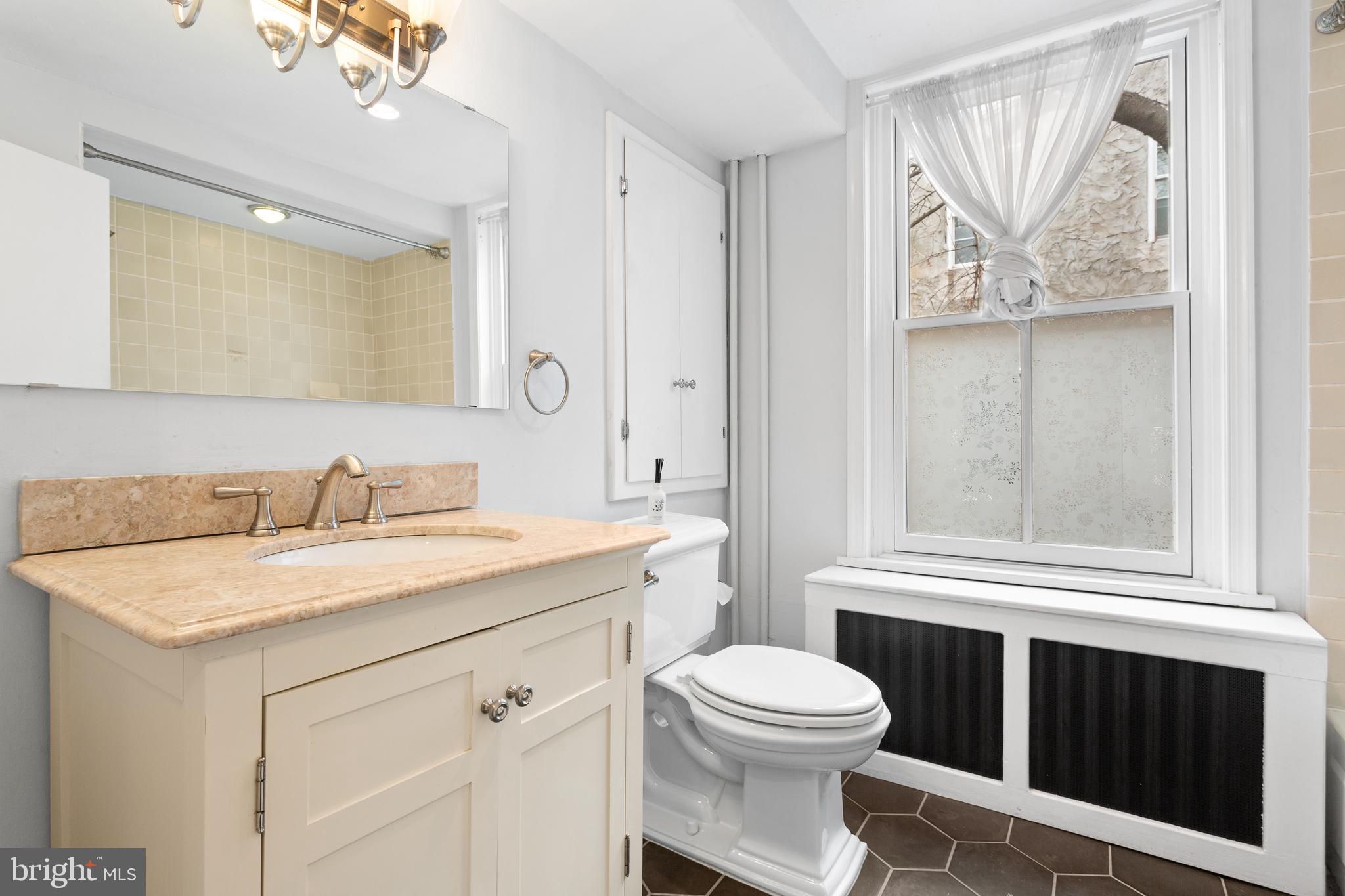 504 Kauffman Street Philadelphia, PA 19147 - Photo 29 of 34 a bathroom with a sink a toilet and a mirror