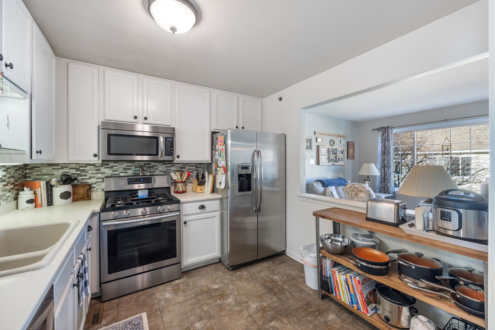 346 Springmist Court Bolingbrook, IL 60440 - Photo 7 of 19 a kitchen with stainless steel appliances granite countertop a stove and a refrigerator