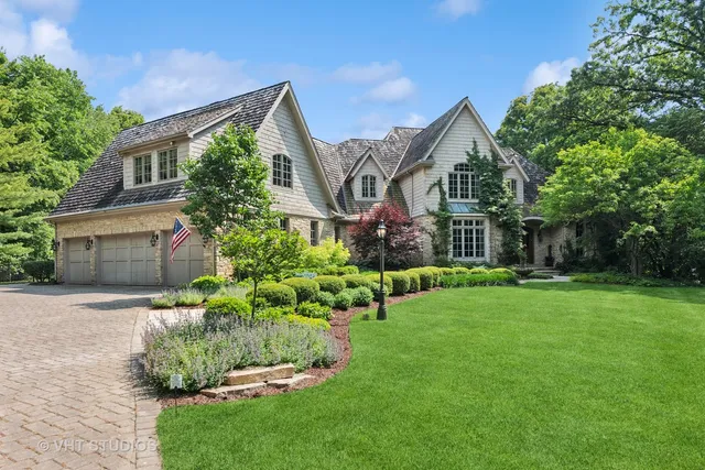 a front view of house with a garden