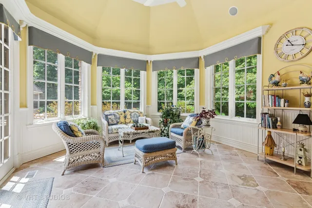 a view of a dining room with furniture and chandelier